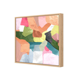 Side view of a colourful abstract painting in an oak look timber frame
